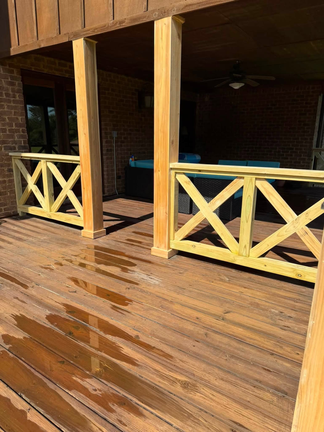 Covered porch with X-rail balustrade and wood decking