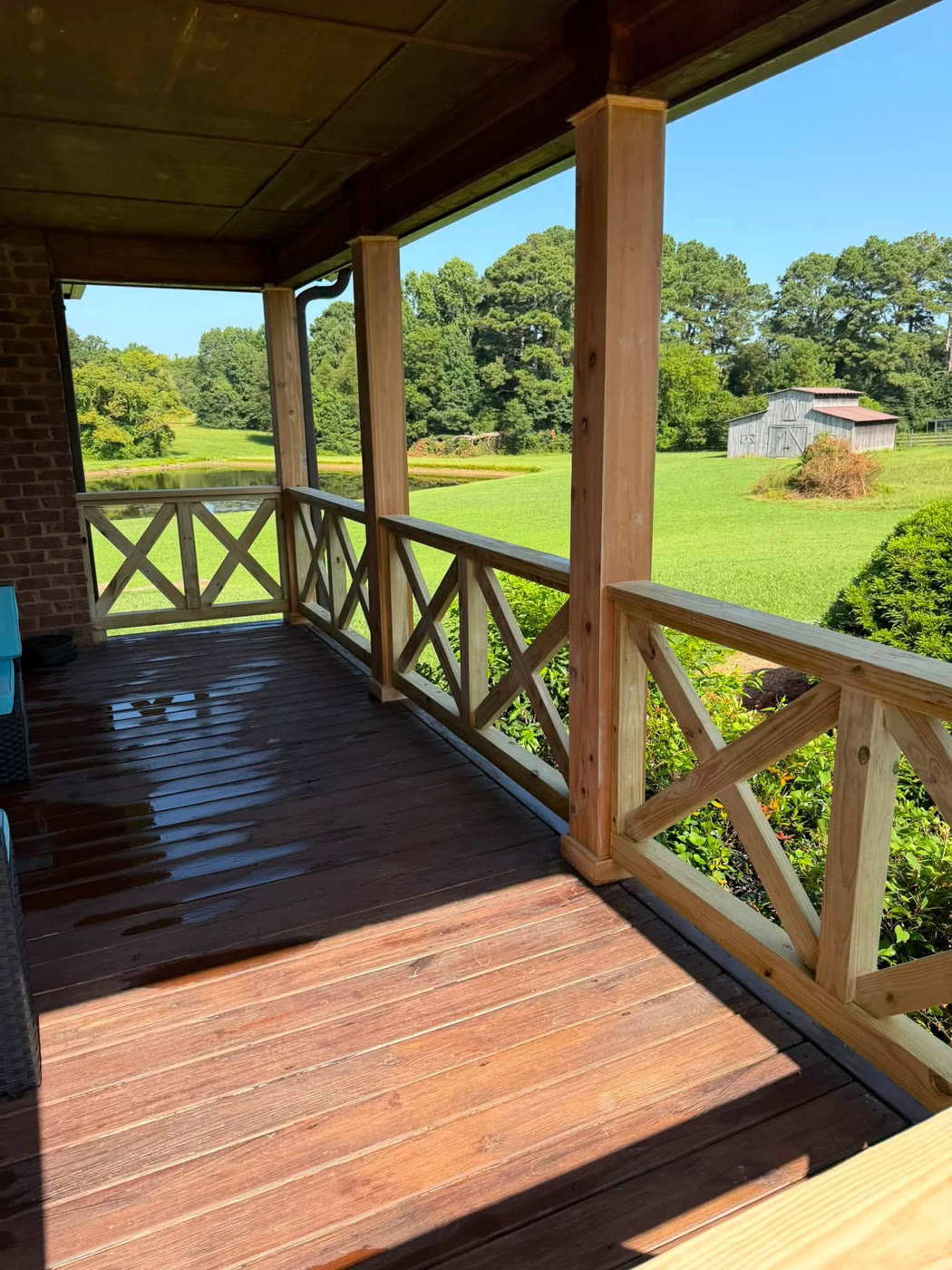 View from the covered porch looking out over the pool and yard