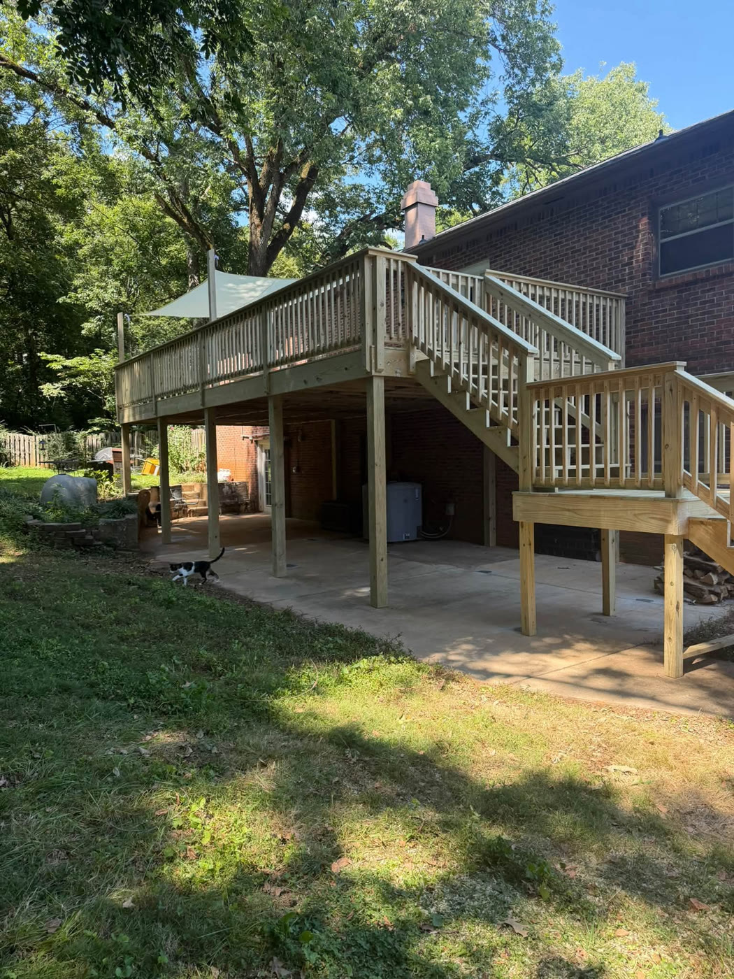Completed elevated wooden deck with railings and stairs